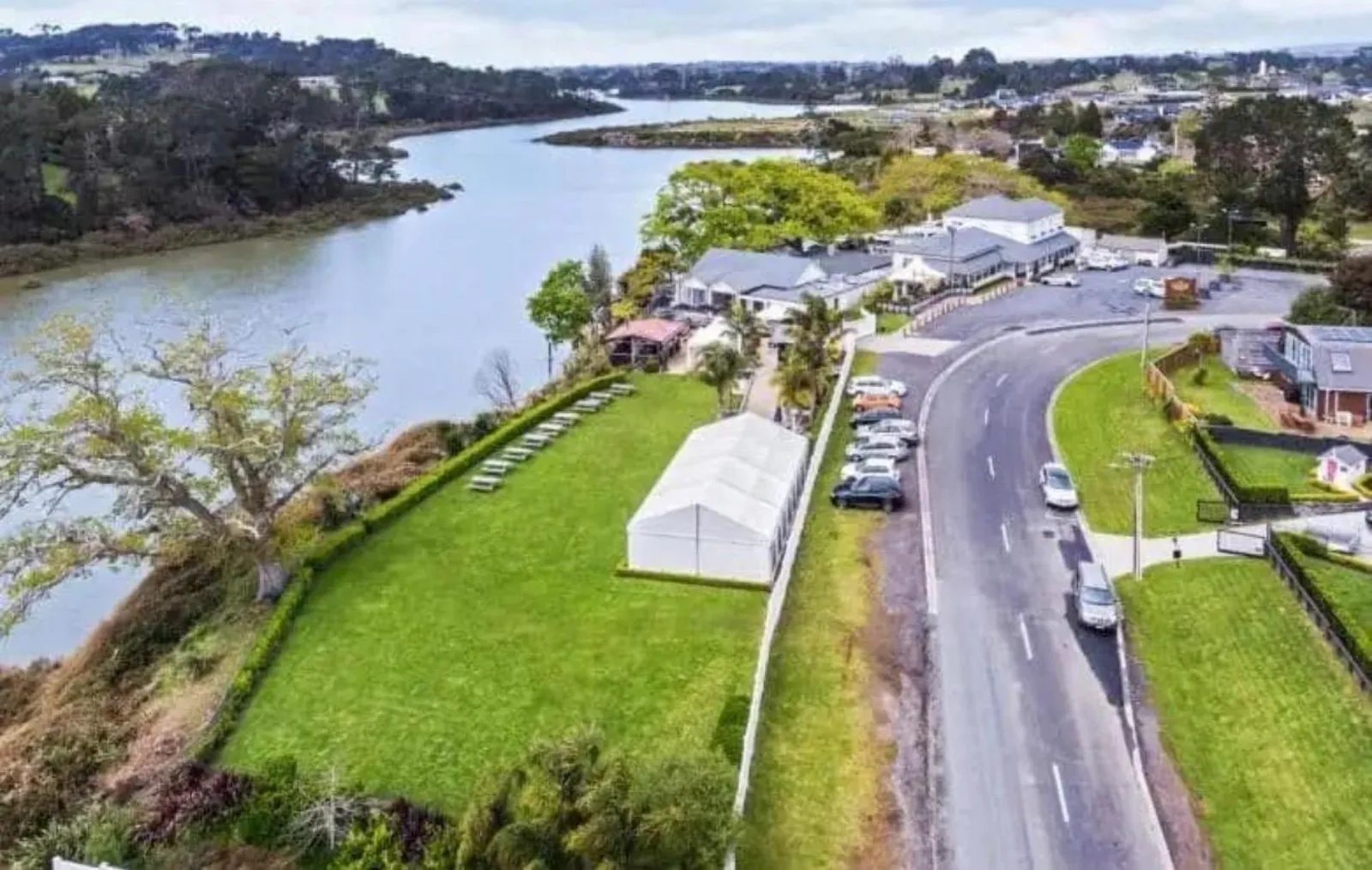 Aerial view of The Riverhead tavern and gardens beside the upper Waitematā